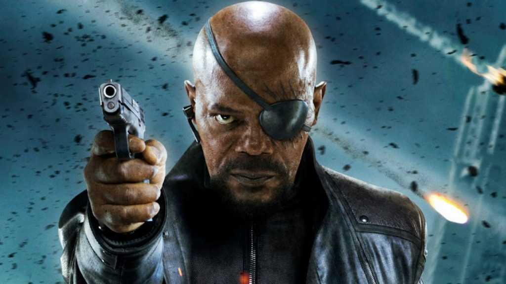 Samuel L Jackson as Nick Fury holding a gun