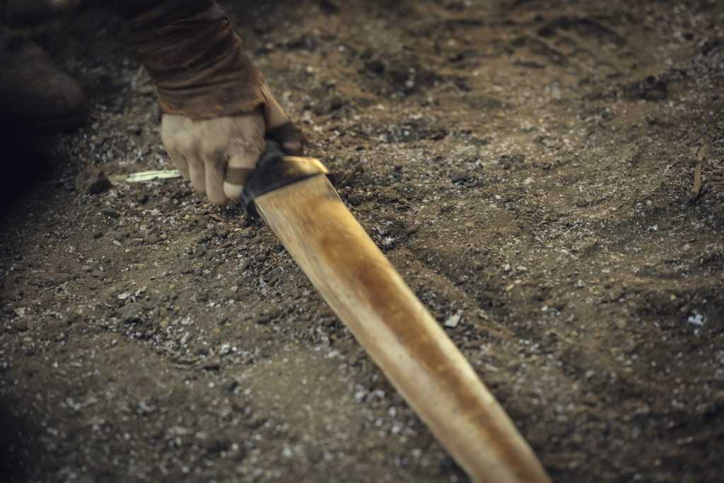 Ciri grabbing what looks like a wooden sword from the ground